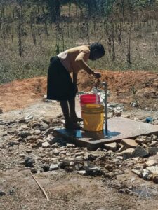 a woman using the new water well