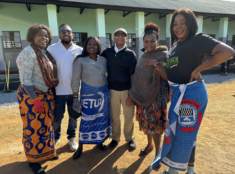 Siksha Founder Ash Patel, and Treasurer and Board Member Neal Patel on a tour of the schools in Zambia that Siksha renovated, and are seen with teachers from Suburbs Girls School in Ndola. 